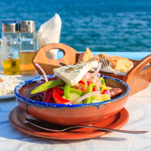 Greek,Salad,On,Table,In,Greek,Tavern,With,Blue,Sea